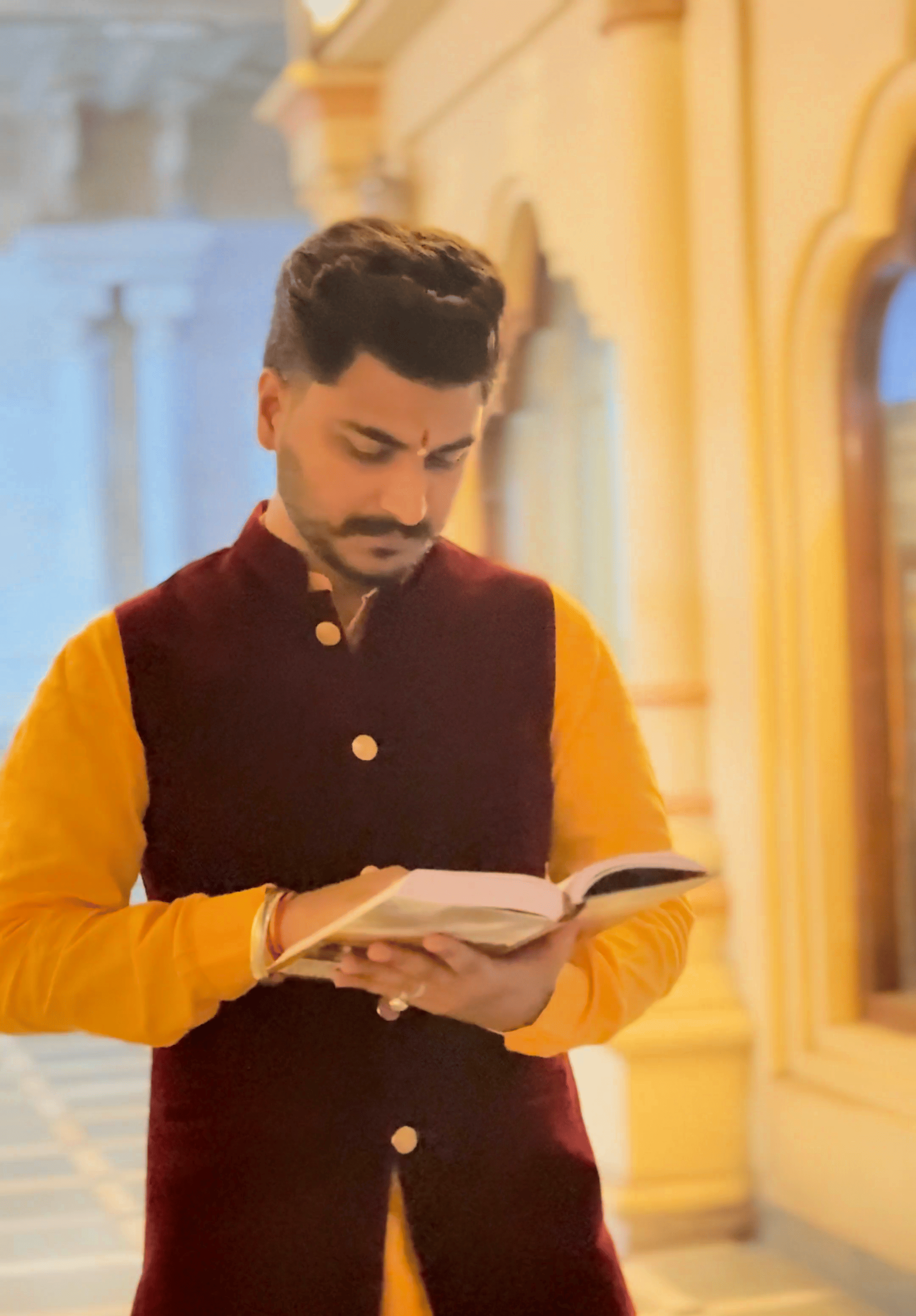 Pt. Deepak Shastri Ji walking and reading